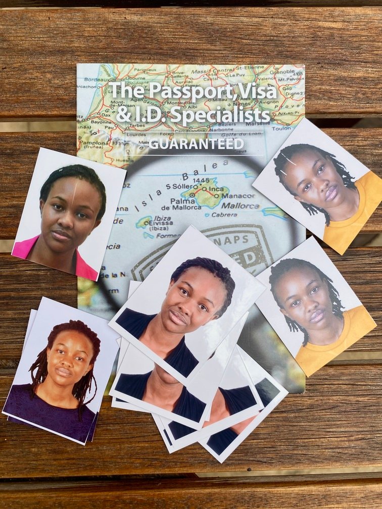 Set of passport photos spread on a table, illustrating documents needed for visa applications.