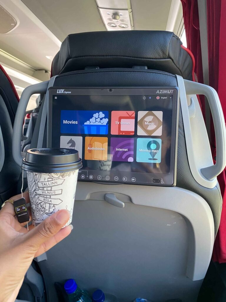 Coffee cup and entertainment options in Lux Express Tallinn to Riga Bus