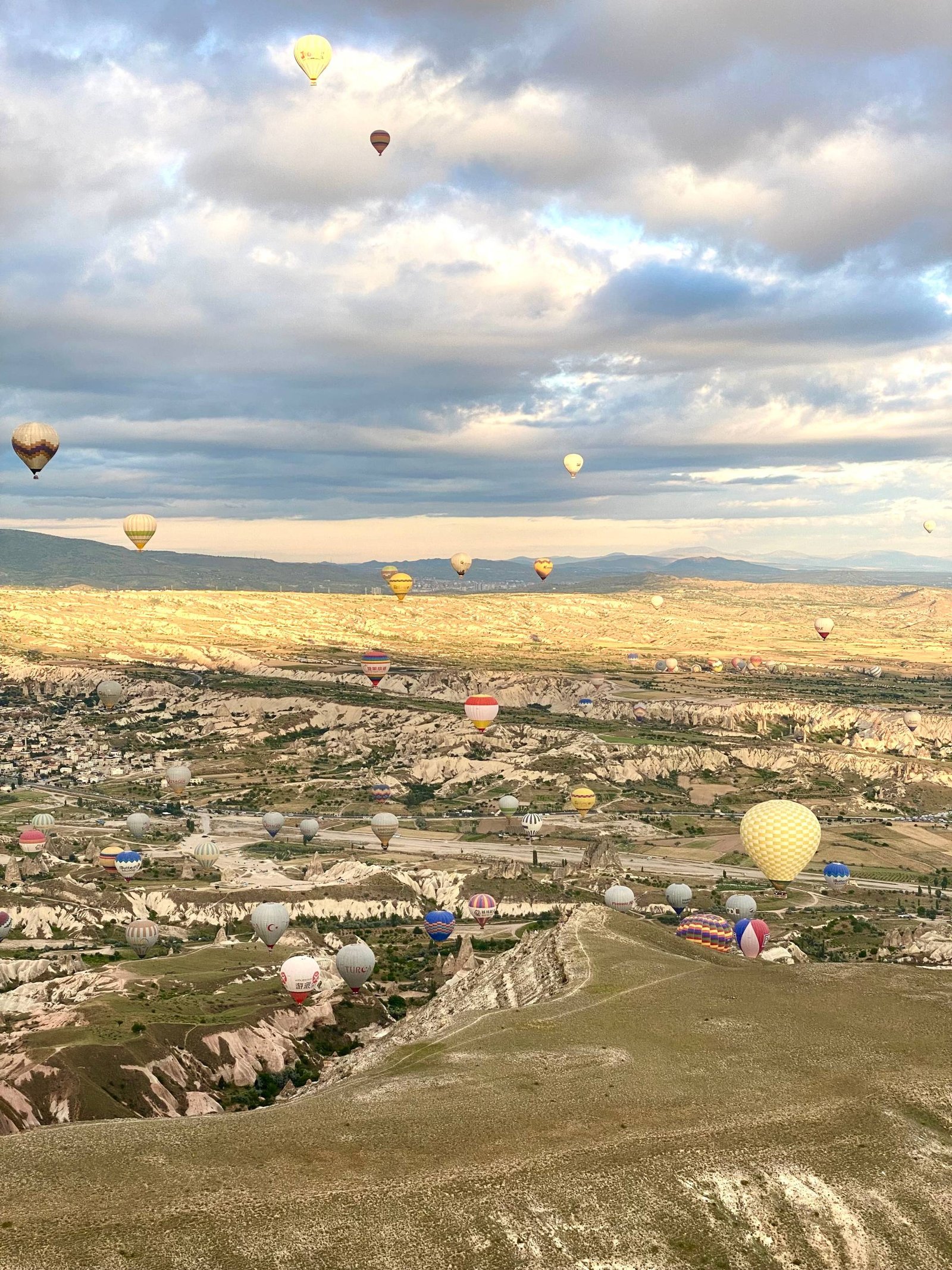 Hot air balloons flying above the ancient lands of Cappadocia, Turkey