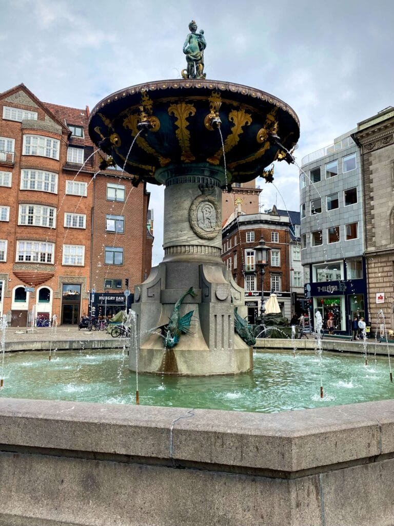 Decorative Water Fountain with buildings in background at City Hall Square near Stroget in Copenhagen, Denmark