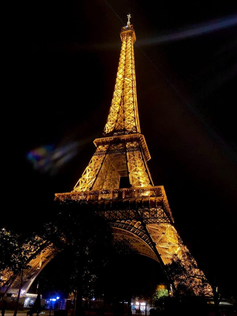 Eiffel tower fully lit at night in Paris, France