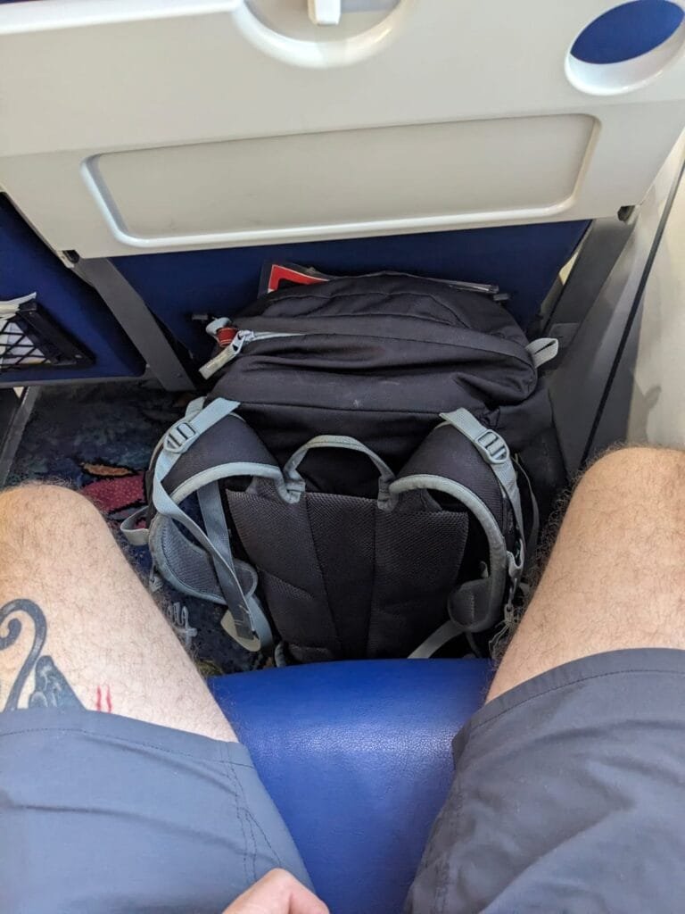 image of white man legs in the trinidad and tobago ferry with luggage beside him