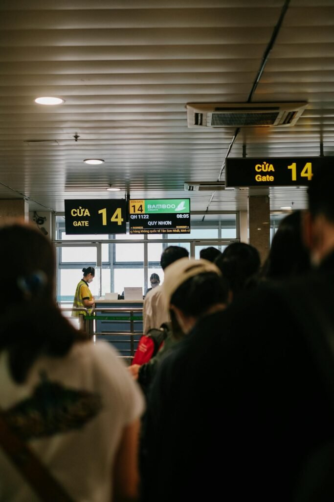 People standing in line at an airport gate, waiting to board a flight.