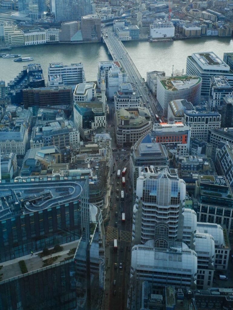Bird’s-eye view from Horizon 22 looking down onto central London streets with traffic, surrounding buildings, and the River Thames in the background.