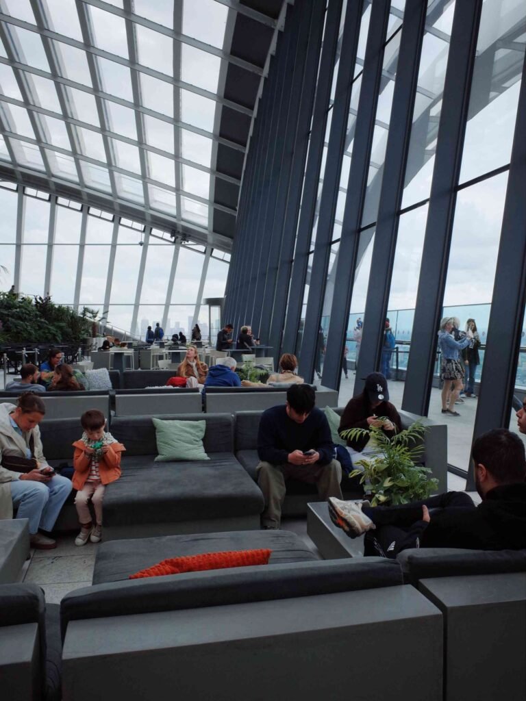 Visitors relaxing in the indoor viewing area at Sky Garden London
